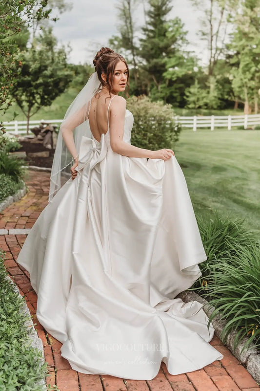 Elegant Satin A-Line Wedding Dress with Spaghetti Straps, Plunging Neckline, Bow Back & Pockets – W2615